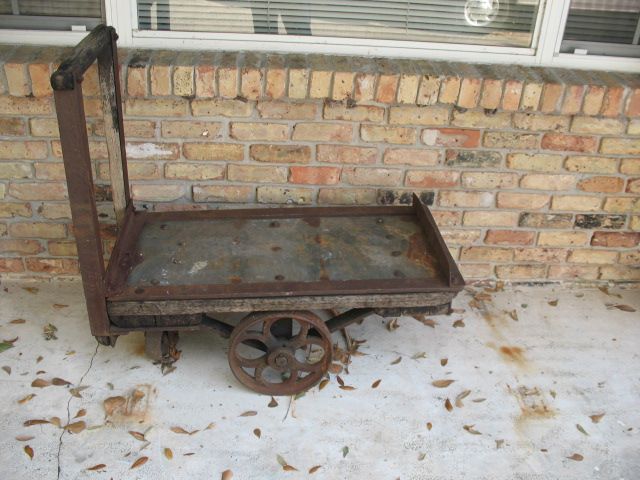 antique industrial cart made of iron and wood great for outside garden 