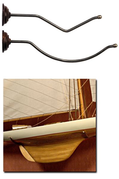 These wood and brass model ship brackets attach to the wall, allowing 